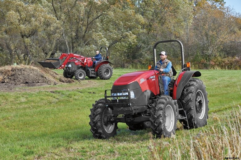 Two Case IH Farmall tractors working in a field